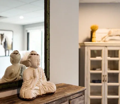 Singing bowl and Buddha statue inside the massage studio