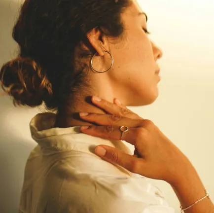 Woman holding the side of her neck