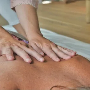 Therapist applying pressure during a back massage