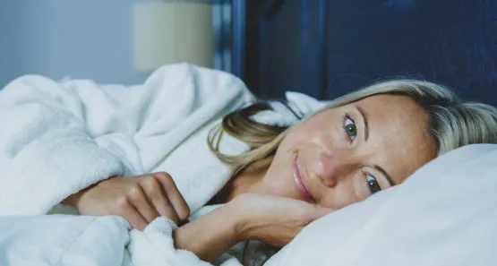 Woman resting awake in bed