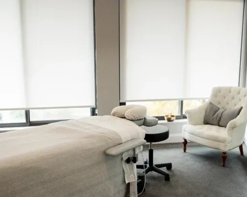 Massage table and seating beside the studio windows