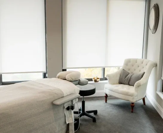 Massage table and seating beside the studio windows